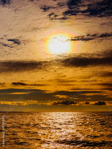 Stormy Sunset Seascape with Bright Sun and Dark Clouds