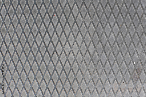 Detail of a rhombuses pattern from a manhole cover, perfect for a background. Old real metal style.