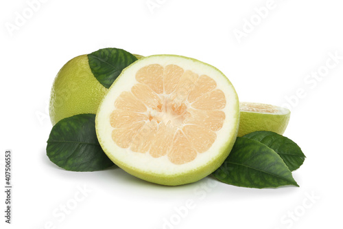 Whole and cut sweetie fruits with green leaves on white background