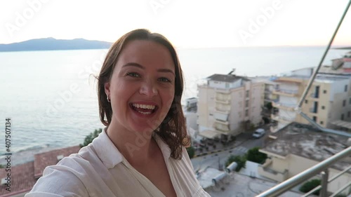 Young happy female traveller making faces at her camera. Selfie concept.