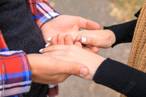 woman and man holding hands in street