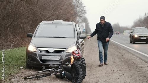 Male driver and female cyclist quarelling after car accident on road. Broken automobile or damaged vehicle, auto collision on highway.