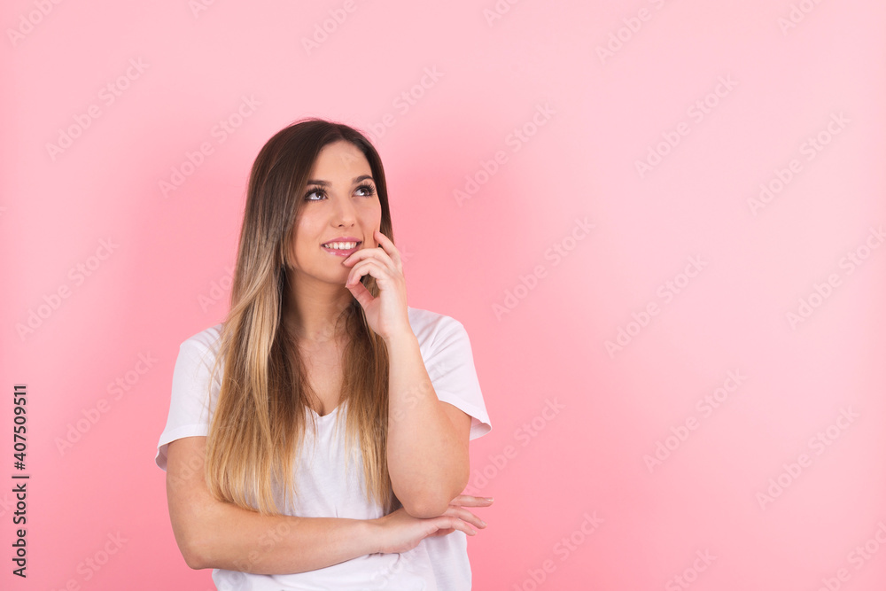 thinking young lady standing isolated over pink background. Looking aside thinking young lady standing isolated over pink background. Looking aside
