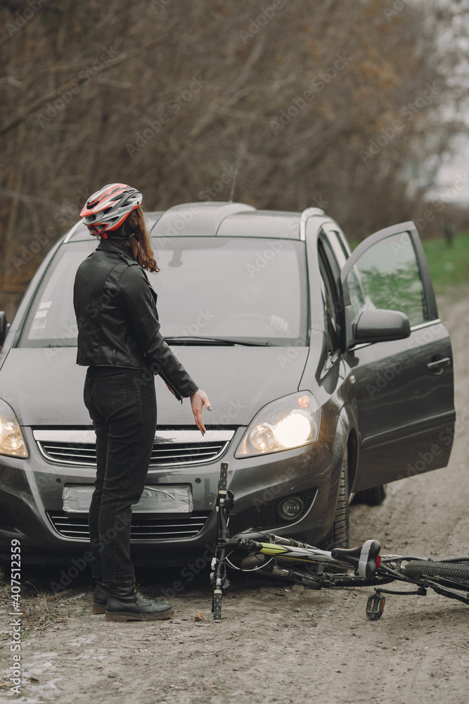 The woman crashed into the car. Girl in a helmet. People quarrel over the accident. The woman crashed into the car. Girl in a helmet. People quarrel over the accident.