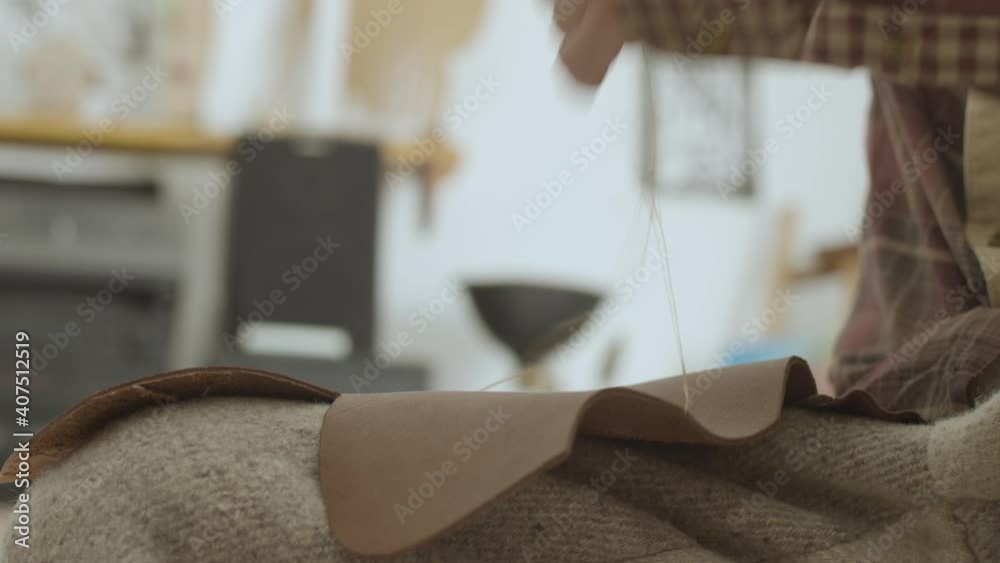 Observe the intricate process in this zoomed in video of a person skillfully stitching the leather, to make moccasin, in La Pocatiere. Observe the intricate process in this zoomed in video of a person skillfully stitching the leather, to make moccasin, in La Pocatiere.