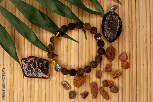 raw amber and amber in products on a natural background