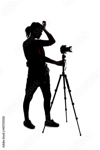 Silhouette of a photographer with a camera on a white background isolated for composites. She is posed as if angry or frustrated