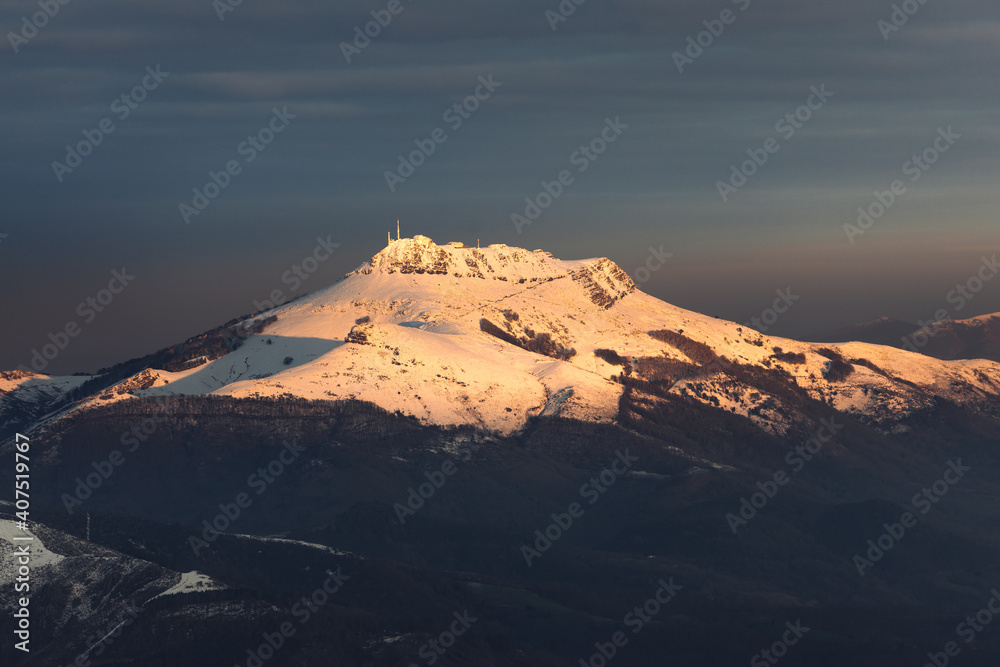 Naklejka premium View of Larrun mountain covered by snow at a winter evening; Basque Country.