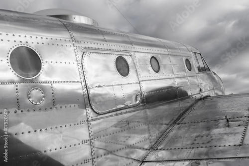 Obraz na płótnie Shiny metal fuselage of a classic, stylish historic airplane in black and white