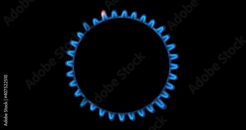Gas stove being turned on by a lit burner. Natural gas concept.