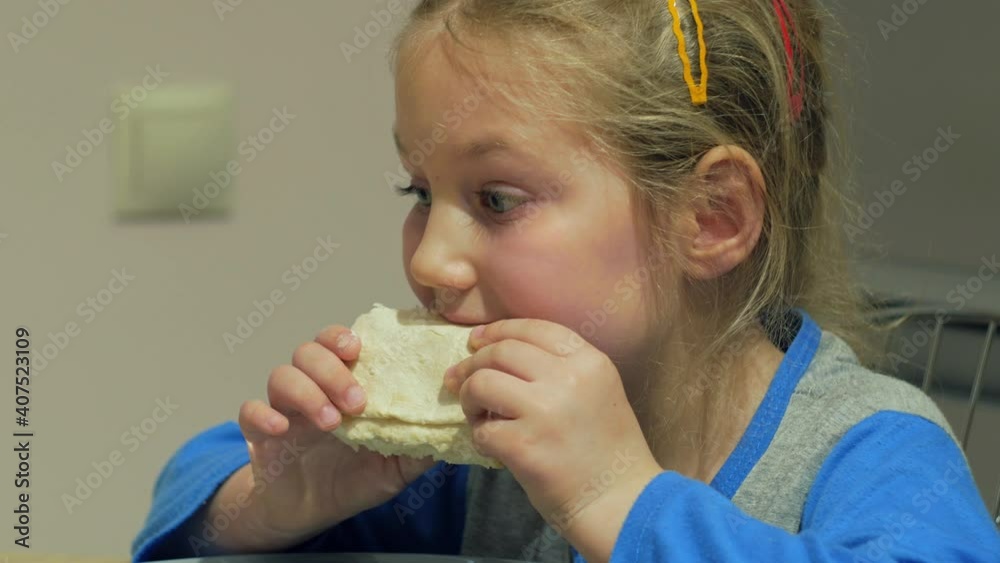 Kid eats thin flatbread cheese roll in the kitchen. Happy child eating having a dinner. Homemade healthy Shawarma food. Lavash traditional caucasus tandoor bread. Soft tortilla wraps tacos burritos. Kid eats thin flatbread cheese roll in the kitchen. Happy child eating having a dinner. Homemade healthy Shawarma food. Lavash traditional caucasus tandoor bread. Soft tortilla wraps tacos burritos.