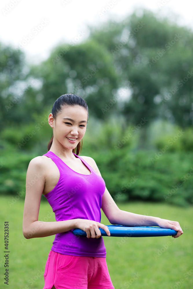 Young woman holding a swimming floating plate