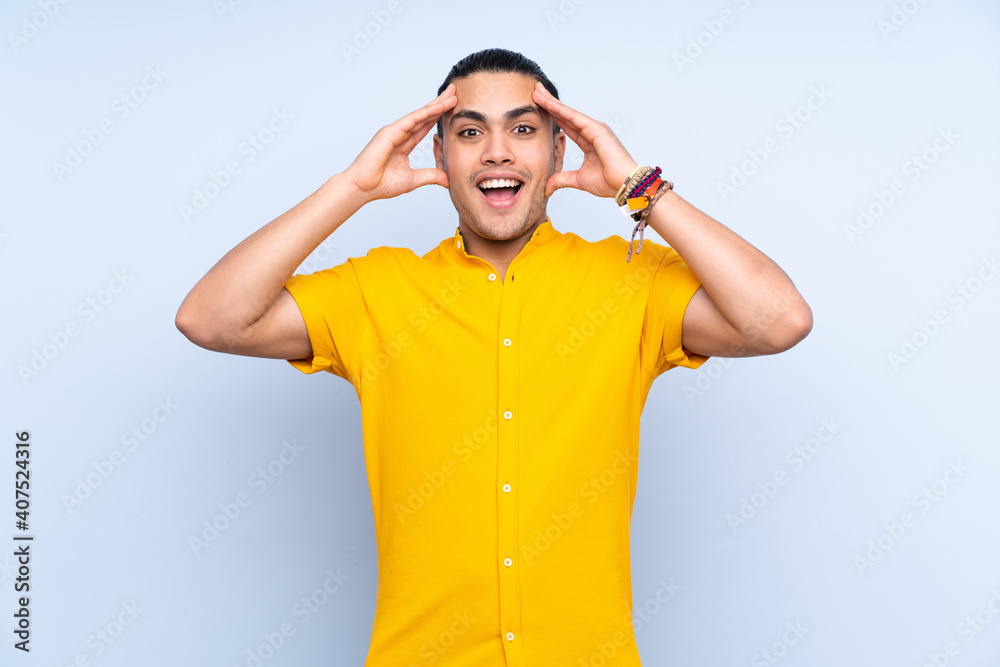 Asian handsome man over isolated background with surprise expression Asian handsome man over isolated background with surprise expression
