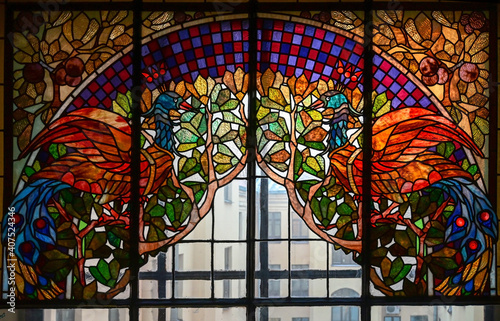 Vintage stained glass window in the stairwell of an old house.