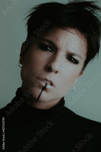 A powerful portrait of a confident woman looking at camera with very dark eyes