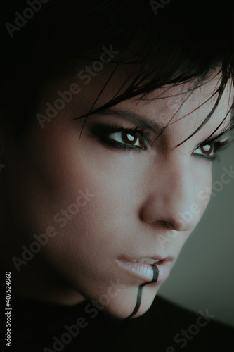 Close up portrait of a beautiful serious woman with dark eyes