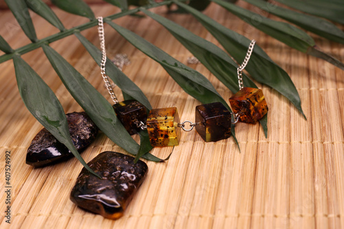 raw amber and amber in products on a natural background