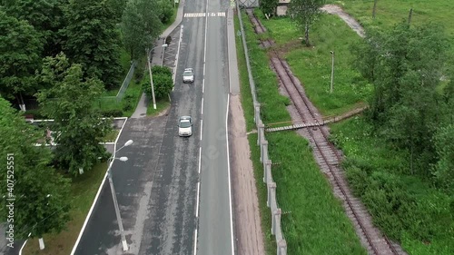 Two police cars are driving down the road. Aerial view.