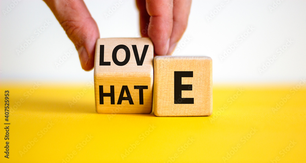 From hate to love symbol. Hand turns the cube and changes the word ...