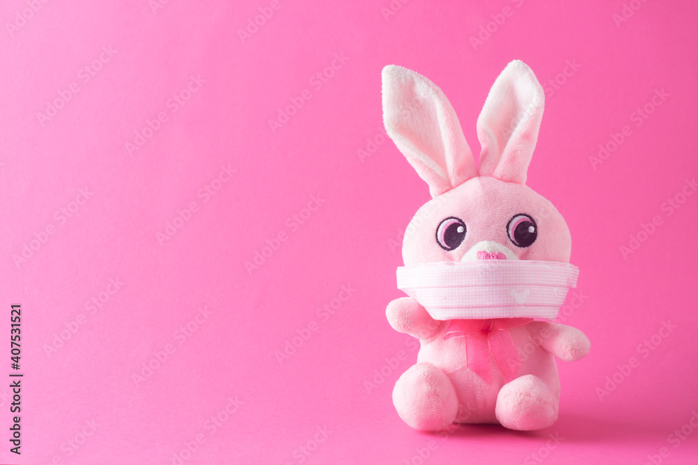 Easter rabbit with face mask - minimal concept of protection from Coronavirus. Easter holiday 2021 during Covid-19. Easter rabbit with face mask - minimal concept of protection from Coronavirus. Easter holiday 2021 during Covid-19.