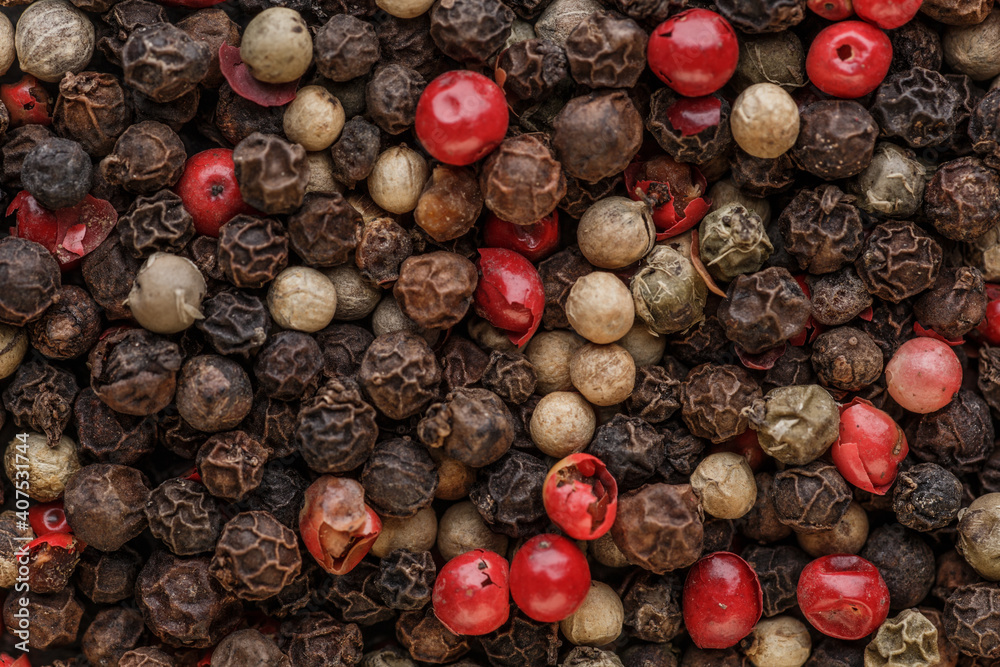 Close up of Mixted multi coloured peppercorns. white, black and green peppercorns macro background.Mixed peppercorns red black and white in bowl - Close-up. Close up of Mixted multi coloured peppercorns. white, black and green peppercorns macro background.Mixed peppercorns red black and white in bowl - Close-up.