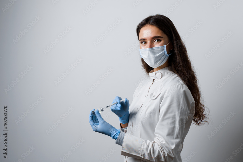 Doctor holding syringe with coronavirus vaccine. Covid-19 Vaccination. Stop quarantine. Attractive girl in medical gloves with syringe and medication Doctor holding syringe with coronavirus vaccine. Covid-19 Vaccination. Stop quarantine. Attractive girl in medical gloves with syringe and medication