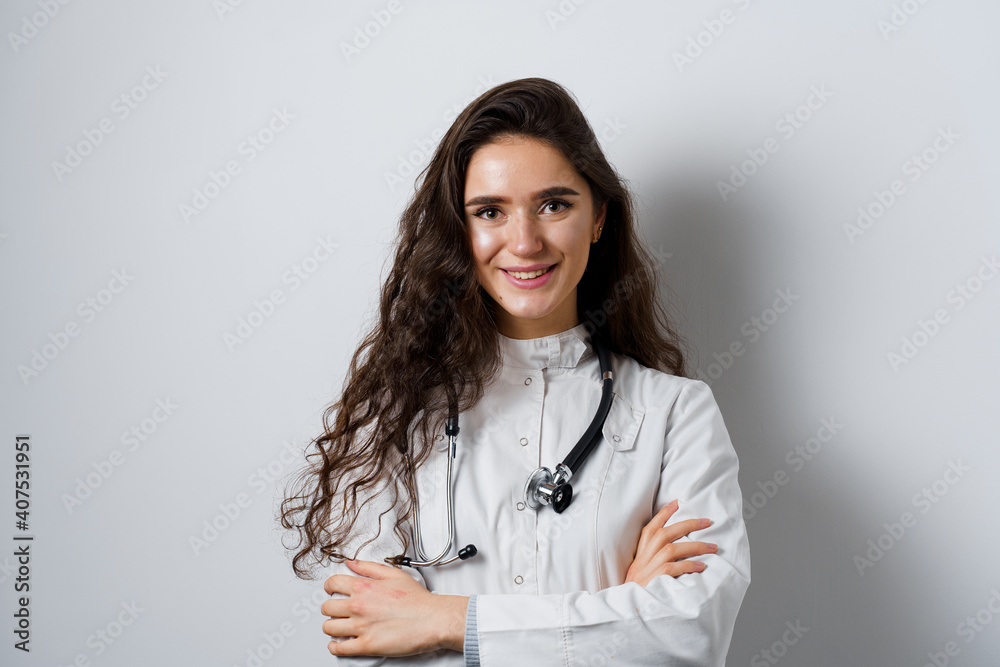 Young attractive girl doctor in medical robe. Young woman smiling on white background. Advert for medical clinic and blogs. Young attractive girl doctor in medical robe. Young woman smiling on white background. Advert for medical clinic and blogs.