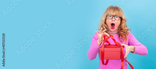 woman opening gift box with surprise