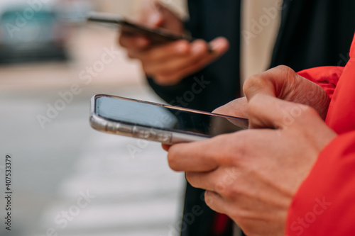 hands of young people with mobile phones