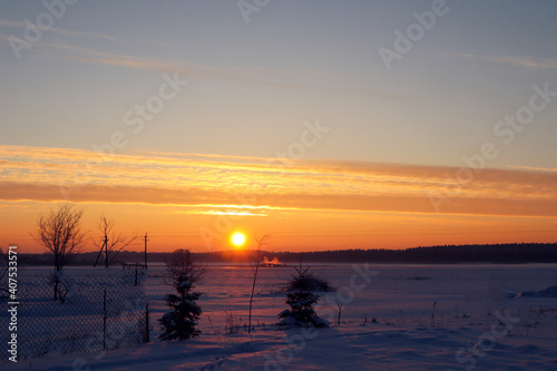 Sunrise over a winter field  early morning  rustic landscape