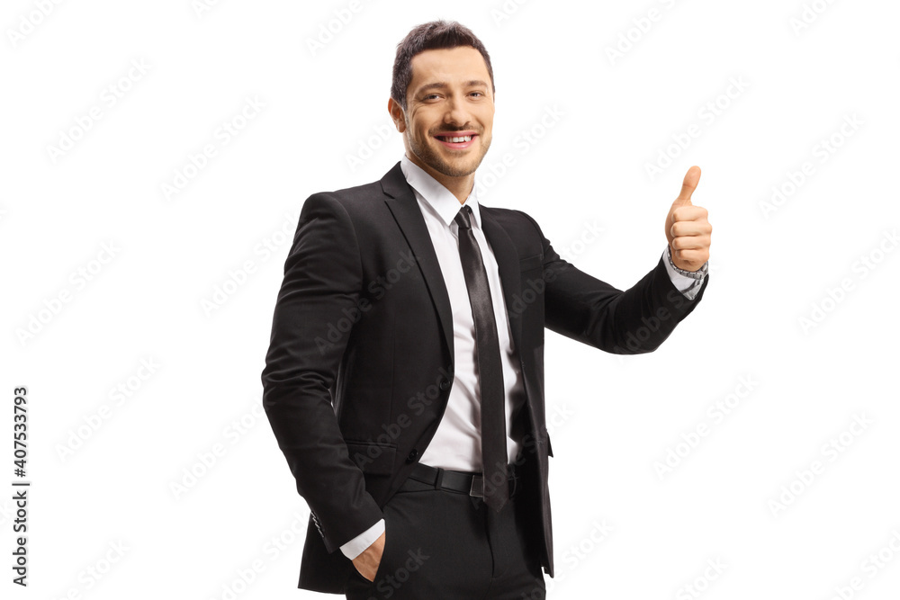 Smiling man in a black suit showing thumbs up Smiling man in a black suit showing thumbs up