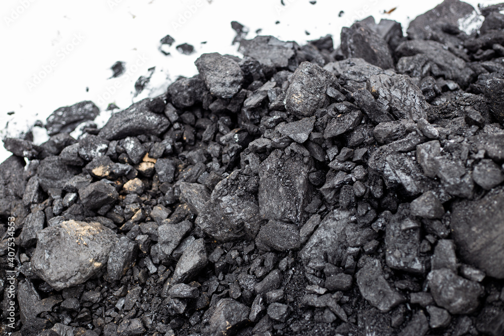 Coarse coal in the snow in winter. Maintaining high temperatures in fuel boilers, home heating systems. Combustible mineral Coarse coal in the snow in winter. Maintaining high temperatures in fuel boilers, home heating systems. Combustible mineral
