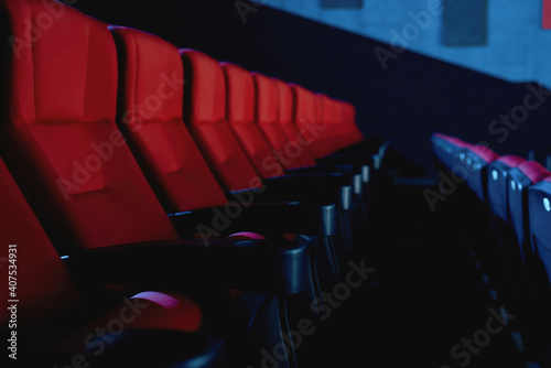 Close up shot of line of red seats in empty cinema auditorium
