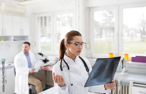 Doctor looking at xray of lungs photo