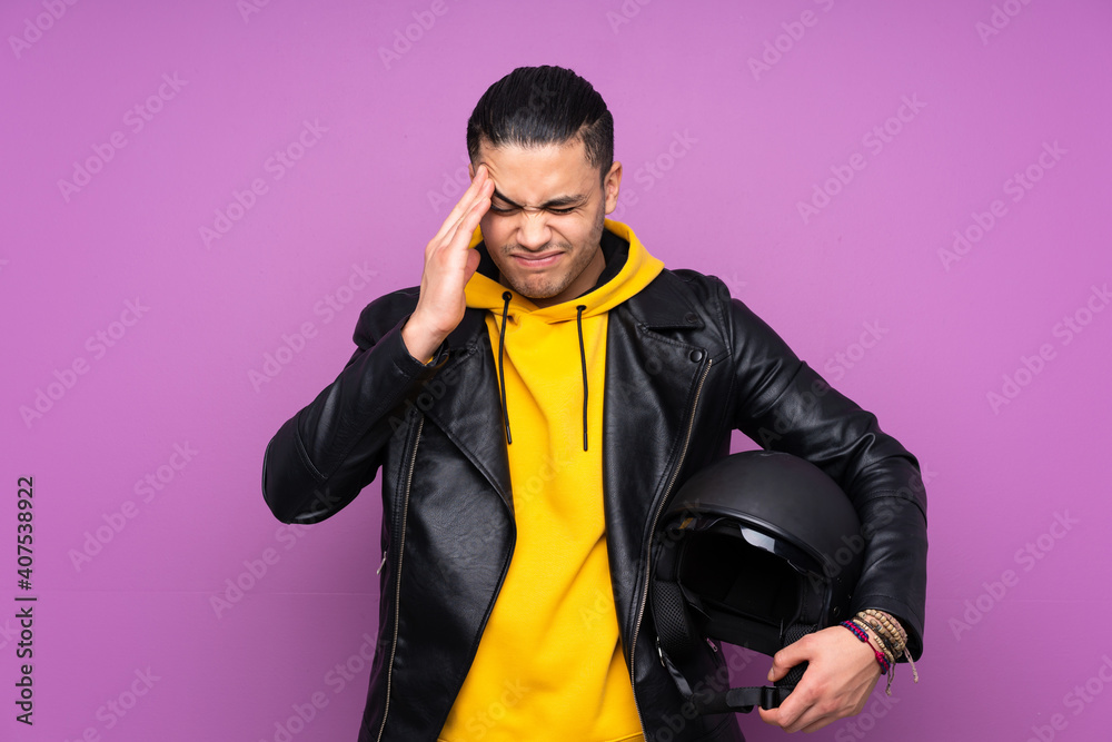 Man with a motorcycle helmet isolated on purple background unhappy and frustrated with something. Negative facial expression Man with a motorcycle helmet isolated on purple background unhappy and frustrated with something. Negative facial expression