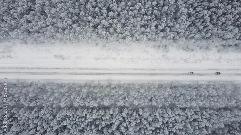 Aerial top view from drone, birds eye view of winter landscape and snowy ice road, car moving on area surrounded by beautiful coniferous forest 4k. Aerial top view from drone, birds eye view of winter landscape and snowy ice road, car moving on area surrounded by beautiful coniferous forest 4k.