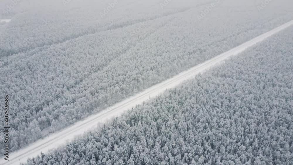 Aerial top view from drone, birds eye view of winter landscape and snowy ice road, car moving on area surrounded by beautiful coniferous forest 4k. Aerial top view from drone, birds eye view of winter landscape and snowy ice road, car moving on area surrounded by beautiful coniferous forest 4k.