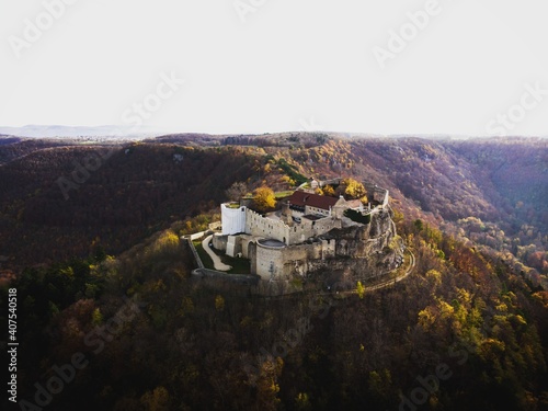 Panorama view of Burgruine Hohenneuffen castle ruins on top of hill near Neuffen BaWu Germany in autumn fall foliage photo