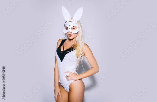 Beautiful young woman in white mysterious mask. Beautiful woman with babbit bunny mask on isolated background wirh copy space.