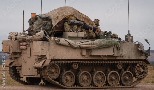 Leinwand Poster british army FV430 in motion, fully loaded with troop bergens under a tarpaulin