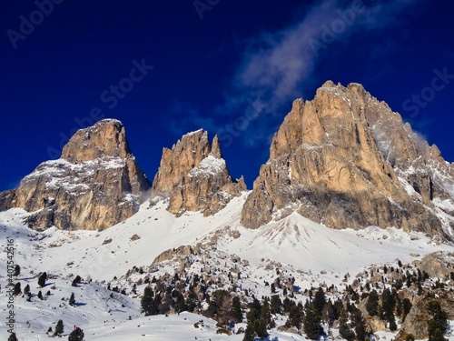 Majestic Snowy Rock in Selva di Val Gardena. Top of the Rocks in Winter Dolomites Italy with Deep Blue Sky.