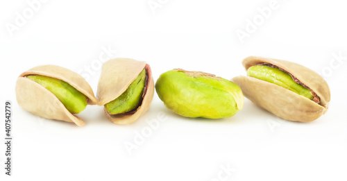 Peeled roasted pistachios isolated on white background, healthy nut