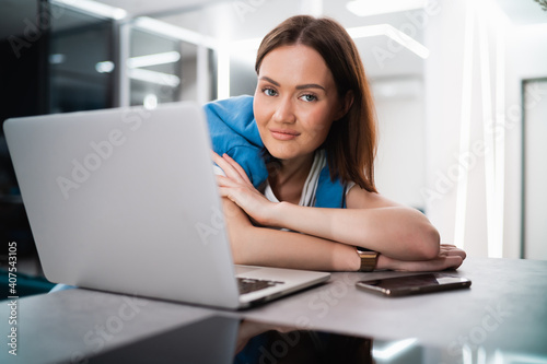 Woman on remote work or online education, using laptop computer, making notes, indoors at home. Online business, young professional at workplace. Working from home.