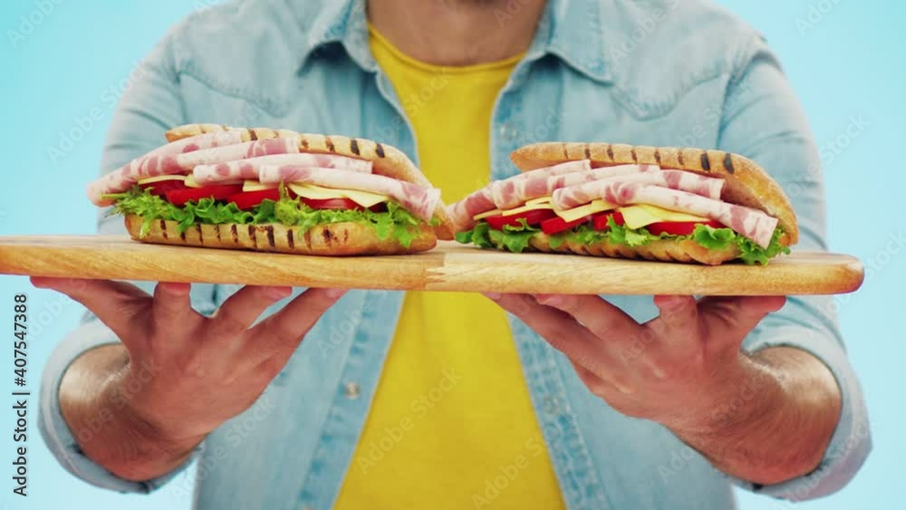 The delicious beef salami sandwich is extended to the camera. The