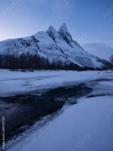 Norway. Frozen river and mountain. A classic view in Norway during winter. Cold weather and a snow storm.