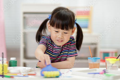 young girl decorating hand made craft for homeschooling