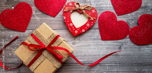 gift box and valentine hearts on wooden background. banner