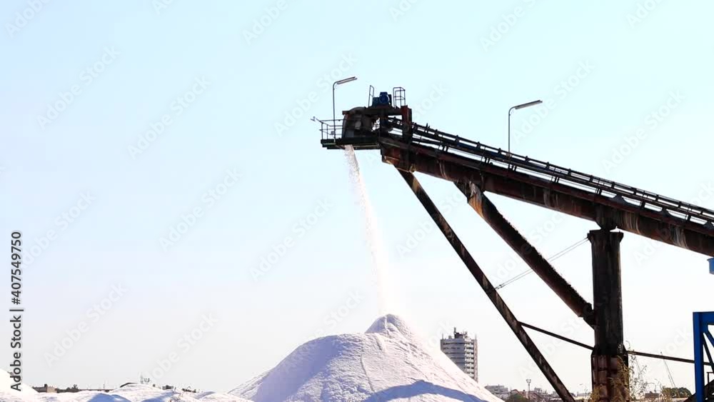 Salt production, conveyor belt with marine salt produced by the evaporation of seawater.