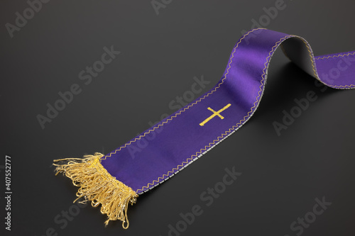 Purple violet priest's stole on a black background