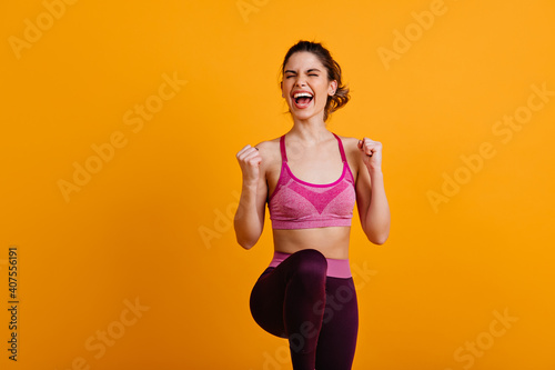 Ecstatic woman doing zumba. Enchanting girl enjoying training. photo